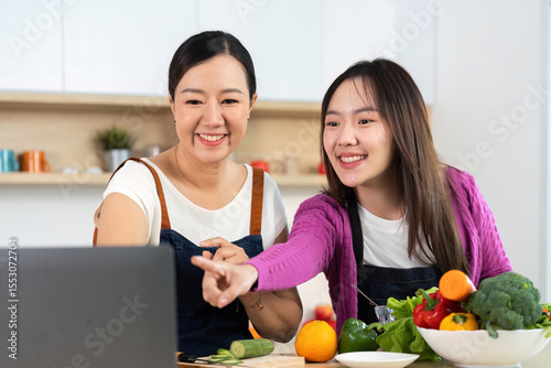 Healthy Cooking Together. Two women enjoying a cooking session with fresh vegetables. photo
