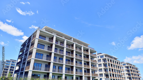Exterior of a high modern multi-story apartment building - facade, windows and balconies.