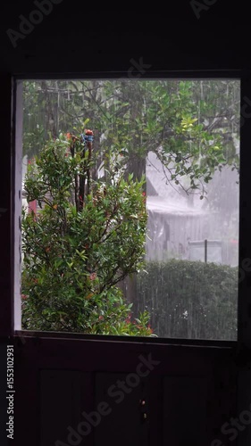 Heavy rain outside the house, window silhouette