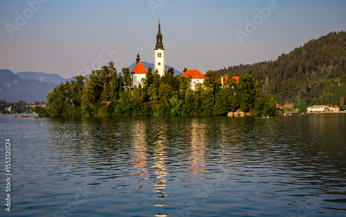 summer evening at Lake Bled - the island with the church are illuminated by the setting sun