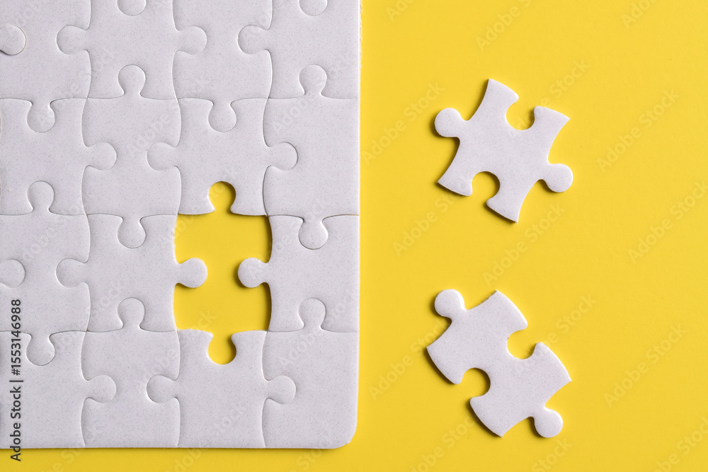 Fototapeta premium White puzzle with missing piece on yellow background. Flat lay. Top view