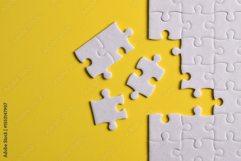 Fototapeta premium White puzzle with missing piece on yellow background. Flat lay. Top view
