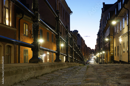 Close-up of cobblestone street in city at night