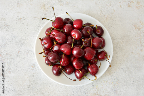 Freshly Picked Cherries on a White Plate top view