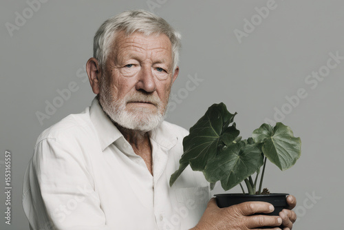 serene portrait of gardener holding flower pot positioned to right of frame