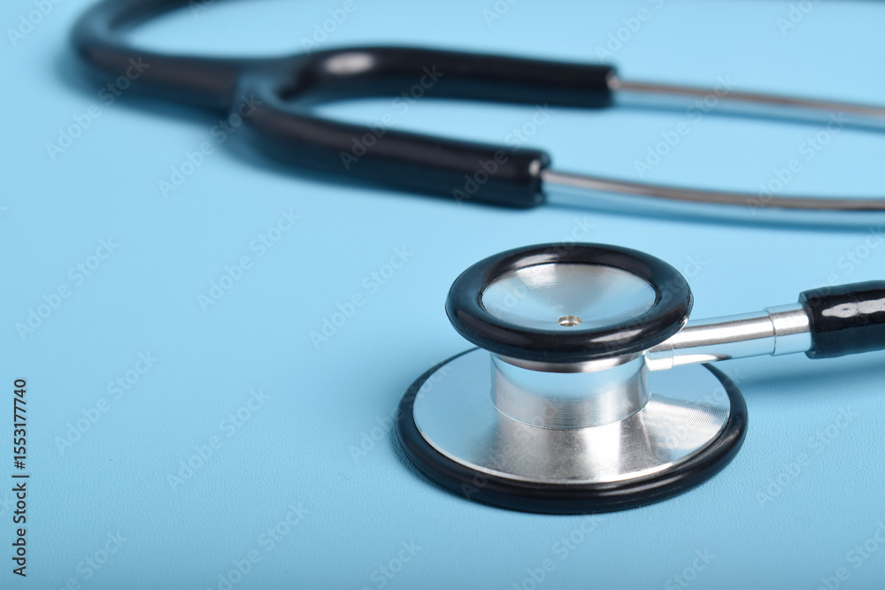 Stethoscope on light blue background, closeup Stethoscope on light blue background, closeup