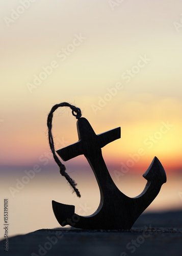 Sunset Reflections with a Wooden Anchor by the Sea