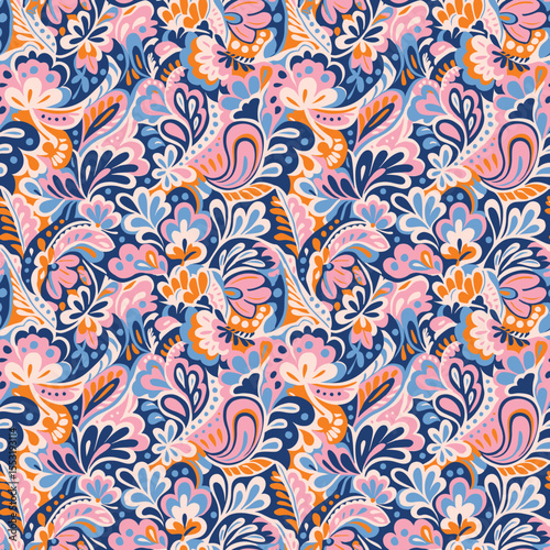 Vibrant retro paisley seamless pattern with intricate floral details. A 70s-inspired design in pink, orange, and blue on a navy background. Ideal for boho fashion, textiles, and bold stationery