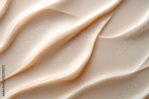 Close-up of smooth, creamy beige textured surface with flowing, wavy patterns and soft shadows creating a gentle, calming effect