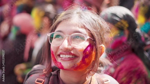 4K Portrait of Indian woman traveler covered in colorful powder during Holi festival in Sangla, Himachal Pradesh, India. Hindu girl celebrate Holi festival. Travel and Indian cultural experience.