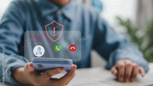 Mobile phone receiving scam call from unknown number with security alert symbol. Illustrates phone fraud, cyber threat, identity theft risk, and awareness of suspicious communication.