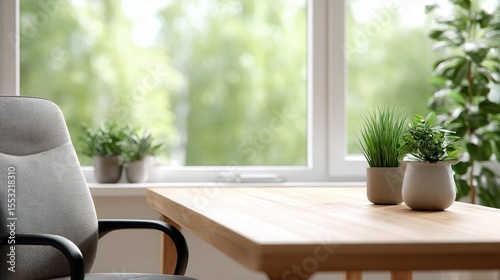 Cozy home office interior with wooden desk and houseplants by sunlit window.