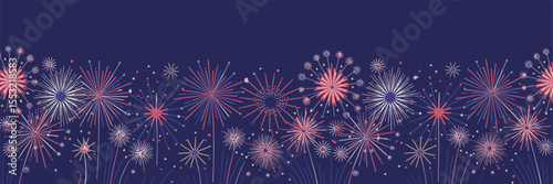 Colorful fireworks bursting in a dark blue night sky, creating vibrant starburst patterns for festive events and holiday celebrations