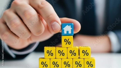 a person holding a home icon cube on top of a stack of percentage cubes, symbolizing real estate and finance