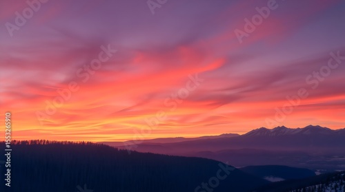 Winter sunrise over distant mountain ridge