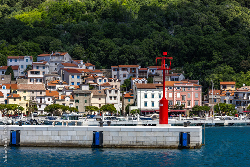 Pier with a lighthouse in Baska on the island of KRK, photo