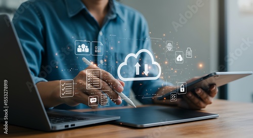 Man working with cloud computing data transfer and digital file management on various devices