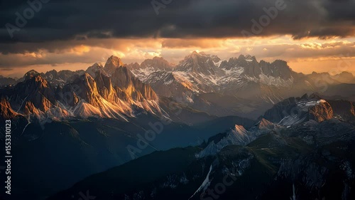 mountain range at sunset in Italy, with a dramatic sky and golden light