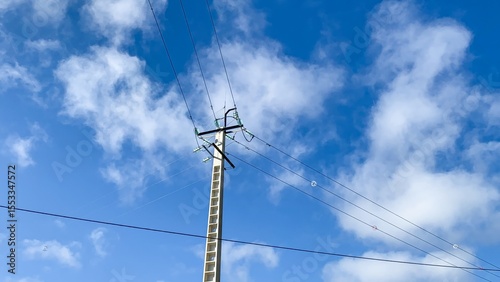 Stark power lines dissect azure skies, evoking Silent Sky Day and Be Kind to Humankind Week's interconnected energies