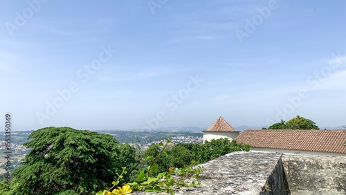 Ancient fortress whispers over azure hills, blending medieval nostalgia with verdant tranquility, evoking Midsummer and Dia de Portugal reflections