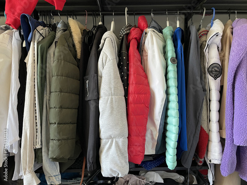 Dressing room, clothes hanging in a row on hangers, winter clothes