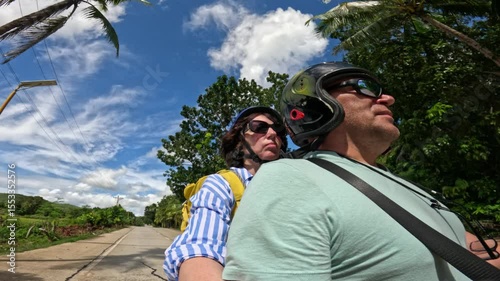 Riders enjoying sunny road journey across Siquijor island in Philippines Riders enjoying sunny road adventure on Siquijor island, Philippines