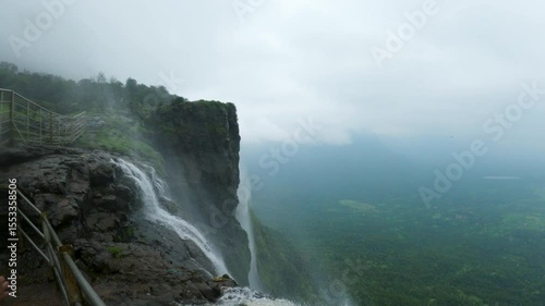 4K shot of reverse waterfall at Naneghat in Maharashtra, India during the monsoon season. Waterfall flows in reverse due to the strong winds in Sahyadri hills. Natural background with copy space.