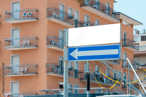 A street sign white mockup in the Italian resort with hotels. Summer sunny day.