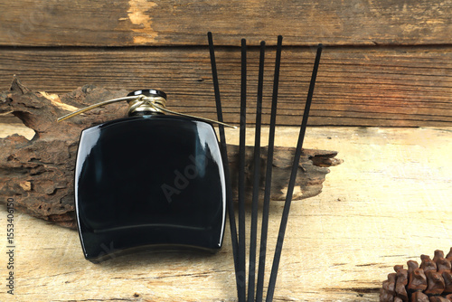 luxury aroma scent reed diffuser glass bottle is on wooden table and vintage wood wall background in nice living room which create relax diffuser aroma ambient scent in room during on Valentine day