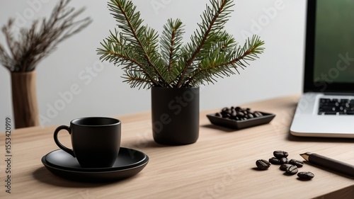 Dark-colored coffee cup and saucer on a light wooden desk.