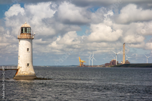 Tarbert Lighthouse and Moneypoint Power Station, Ireland: Historic Beacon Meets Wind Turbines on Shannon Estuary.