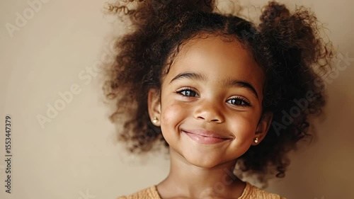 Smiling young girl with curly hair portrait
