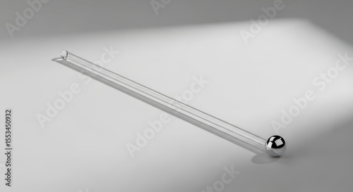 Shimmering Reflection of a Sleek Glass Rod with a Metallic Sphere on Its End