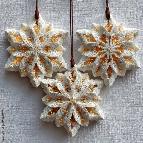 Hanging Snowflake Ornaments with Intricate Paper Filigree Details on Textured White Background