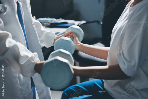 Unrecognizable uses blue hand weight during physical therapy session