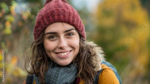 Smiling young woman enjoys the autumn weather in the forest. Autumn landscape