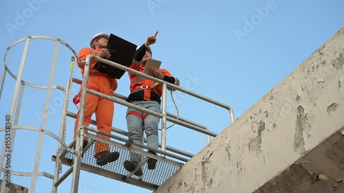Telecommunication Engineers Working on 5G Tower,Technicians Climbing High Telecom Poles,Ensuring Network Maintenance with Safety Equipment