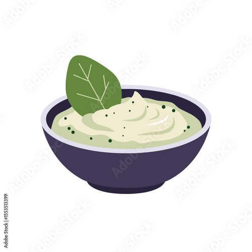 Green vegetable dip served in a dark bowl with a leaf garnish  
