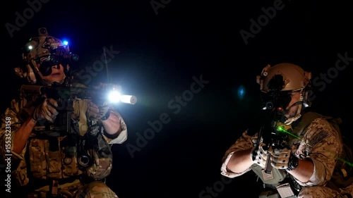 special forces soldiers conduct a night raid using night vision goggles a tactical light and a laser sight A concept for modern warfare and covert operations