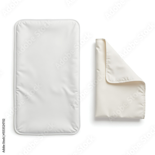 Portable changing mat folded and partially open in neutral colors  