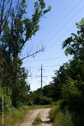 A dirt road with power lines