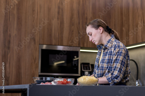 Woman Slicing Ingredients for Quiche in the kitchen.