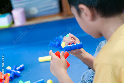 little boy playing with educational toys