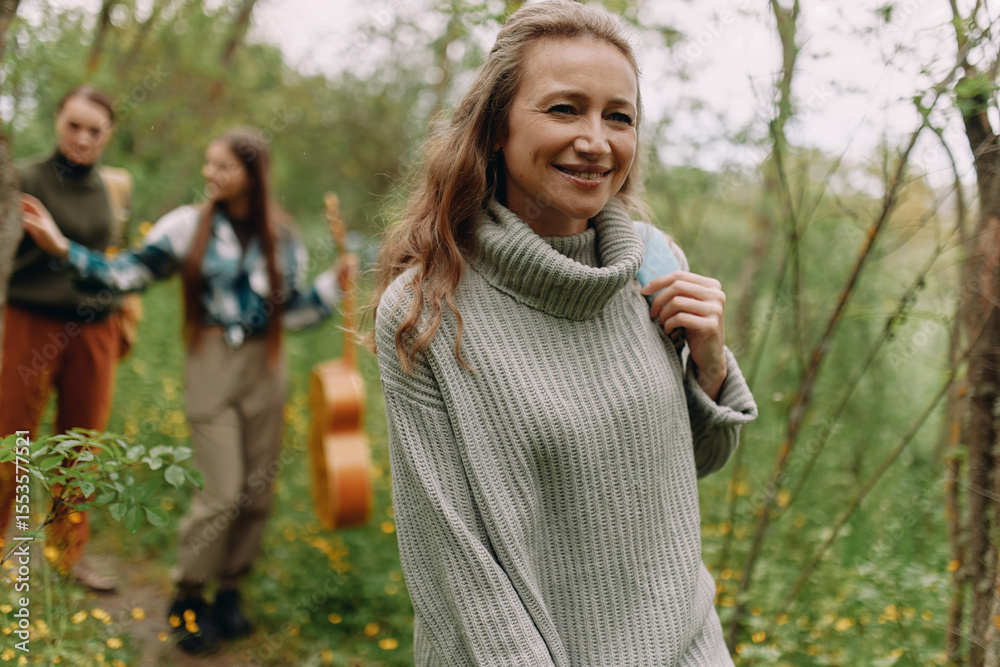 Smiling middle age woman outdoors enjoying active lifestyle, wellness, and wellbeing surrounded by nature, promoting fitness, health, and longevity. Smiling middle age woman outdoors enjoying active lifestyle, wellness, and wellbeing surrounded by nature, promoting fitness, health, and longevity.