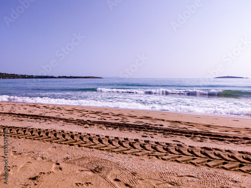 Beach, sea, empty sky and island in the distance