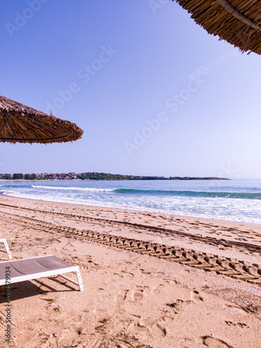 Beach, sea, empty sky and island in the distance
