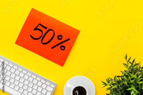 Sales and online shopping concept. Top view of a table with computer and discount percentage sing