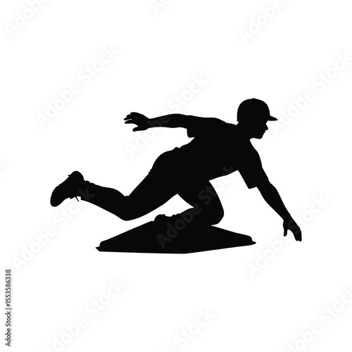 Silhouette of baseball player sliding into base during a game action