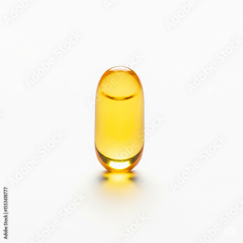 golden softgel capsule centered on white background