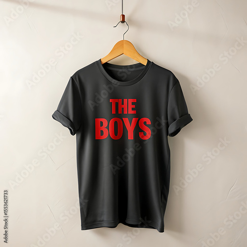 Wallpaper Mural A black tshirt with the text the boys in red is hanging on a wooden hanger against a white wall Torontodigital.ca
